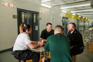 Staff members sat with prisoners at a table in Low Moss