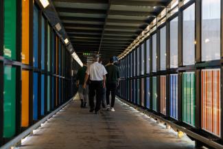 Staff member with a group of prisoners in the walkway at Low Moss