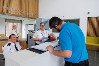 Staff and visitor at reception in Stirling