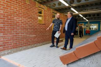 two men walking in construction area