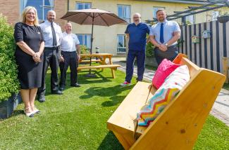 group receiving new garden furniture